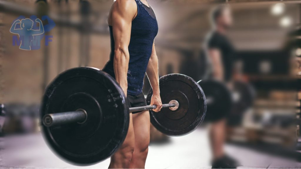 Fit woman in the foreground performing the deadlift with a man performing the deadlift in the background.