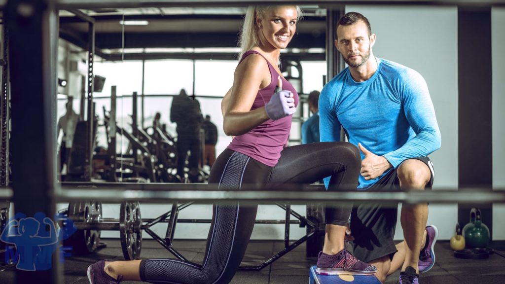 Personal trainer working with pleased client using best personal training certifications.