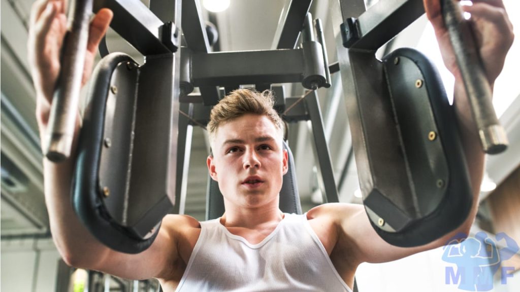 Man performing pec deck flyes