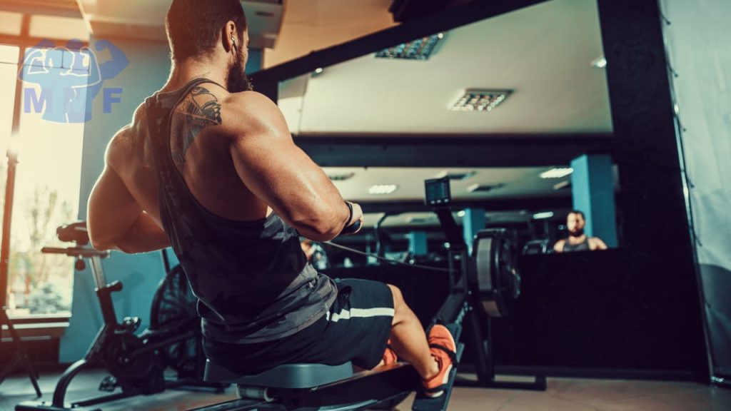 Strong man doing high-intensity interval cardio training on a rowing machine to burn fat fast