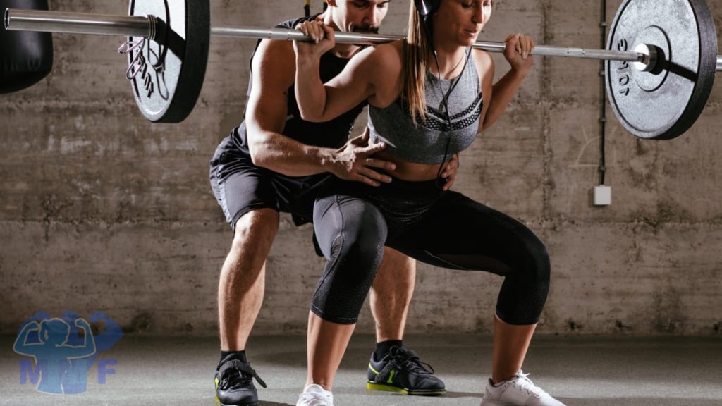 Man spotting a fit woman squatting for the genuine benefits of weightlifting For Your health at any age.