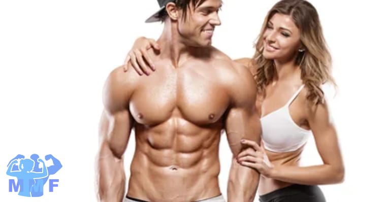 Buff muscular shirtless man with six pack abs and backwards ball cap beautiful sexy woman hanging on him.