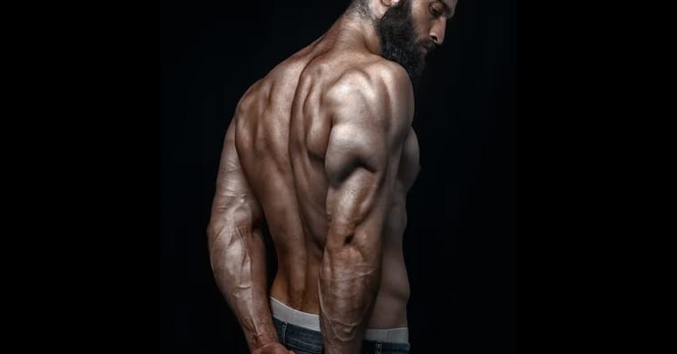 fit man beard strong back and triceps shirtless flexing