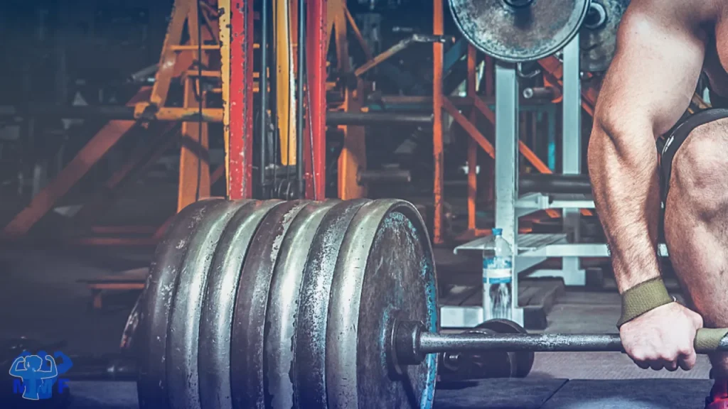 Man setting up heave barbell for deadlift